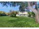 Spacious backyard with well-maintained lawn and mature trees at 6009 Wilshire Dr, Tampa, FL 33615