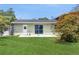 Backyard with green grass, a patio, and landscaping at 6009 Wilshire Dr, Tampa, FL 33615