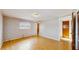 A bright bedroom featuring hardwood floors, a window, and neutral colored walls at 6009 Wilshire Dr, Tampa, FL 33615
