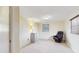 Bedroom featuring tile floors, two windows, and a black reclining chair at 6009 Wilshire Dr, Tampa, FL 33615