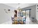 Bright dining room with a glass table, tile floors, and sliding glass doors to the outdoors at 6009 Wilshire Dr, Tampa, FL 33615