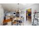 Sunlit dining area with a glass-top table, tile floors, and views into the kitchen at 6009 Wilshire Dr, Tampa, FL 33615