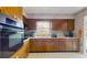 Classic kitchen with wooden cabinetry, white appliances, and a cozy atmosphere at 6009 Wilshire Dr, Tampa, FL 33615