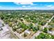 Aerial view of the property showcases lush landscaping and the nearby city skyline at 6020 N 50Th St, Tampa, FL 33610