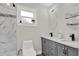 Contemporary bathroom with dual sinks, marble-look shower, and modern fixtures at 6020 N 50Th St, Tampa, FL 33610