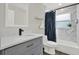 Stylish bathroom features modern vanity and shower with marble-look tile and dark accents at 6020 N 50Th St, Tampa, FL 33610