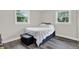 Bright bedroom features two windows, neutral paint, and dark wood floors at 6020 N 50Th St, Tampa, FL 33610