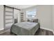 Comfortable bedroom with modern sliding barn door and gray accents at 6020 N 50Th St, Tampa, FL 33610
