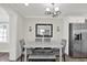 Elegant dining room with a marble table, gray velvet chairs, and modern chandelier at 6020 N 50Th St, Tampa, FL 33610