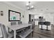 Well-lit dining area features a modern table, stainless steel fridge, and convenient access to the kitchen at 6020 N 50Th St, Tampa, FL 33610