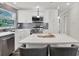 Modern kitchen with white cabinets, stainless steel appliances, and a central island with seating at 6020 N 50Th St, Tampa, FL 33610