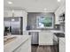 Modern kitchen with stainless steel appliances, subway tile backsplash, and quartz countertops at 6020 N 50Th St, Tampa, FL 33610