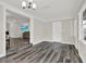 Open-concept living area with updated lighting, dark wood floors, and neutral paint at 6020 N 50Th St, Tampa, FL 33610