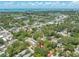 Aerial view of the property and surrounding area, featuring lush trees and ocean views at 612 Sw Beverly Ave, Largo, FL 33770