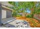 Private backyard featuring a cozy patio area, mature trees, and new fencing at 612 Sw Beverly Ave, Largo, FL 33770