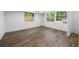 Bedroom featuring wood-look floors and windows, providing lots of natural light at 612 Sw Beverly Ave, Largo, FL 33770