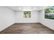 Bright bedroom featuring wood-look floors, windows, and neutral walls at 612 Sw Beverly Ave, Largo, FL 33770