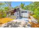 Charming single-story home featuring a gray and white exterior with an American flag at 612 Sw Beverly Ave, Largo, FL 33770