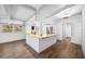 Open kitchen with new appliances, wood countertops, white cabinets, and hardwood flooring at 612 Sw Beverly Ave, Largo, FL 33770