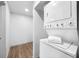 Well-lit laundry room with new white washer and dryer, plus bonus storage area at 612 Sw Beverly Ave, Largo, FL 33770