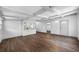 Open-concept living room with coffered ceilings and wood-look floors provides a relaxing space at 612 Sw Beverly Ave, Largo, FL 33770