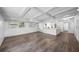Spacious living room with hardwood floors, ceiling beams, and an open layout leading into the kitchen at 612 Sw Beverly Ave, Largo, FL 33770