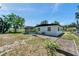 Backyard view with home, screened patio, and landscaping at 6507 La Mesa Cir, Tampa, FL 33634