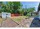 Wide backyard featuring a storage shed, privacy fence, and landscaping at 6507 La Mesa Cir, Tampa, FL 33634