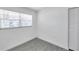 Simple bedroom featuring a window with blinds and light wood-look tile flooring at 6507 La Mesa Cir, Tampa, FL 33634