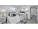 Relaxing bedroom with a well-lit window, wooden nightstand and sleek dresser at 6507 La Mesa Cir, Tampa, FL 33634