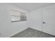 Bedroom with window and wood-look tile flooring at 6507 La Mesa Cir, Tampa, FL 33634