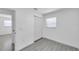 Well-lit bedroom featuring wood-look tile flooring, closet, and window at 6507 La Mesa Cir, Tampa, FL 33634