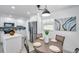 An eat-in kitchen area features stainless appliances, white cabinets, and a round dining table at 6507 La Mesa Cir, Tampa, FL 33634