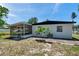 Exterior of the home showing a screened-in patio and a small tree in the yard at 6507 La Mesa Cir, Tampa, FL 33634