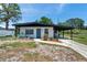 Charming single-story home featuring a covered carport, landscaping, and a well-maintained front yard at 6507 La Mesa Cir, Tampa, FL 33634