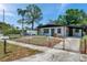Charming single-story home featuring a fenced front yard and a beautifully maintained lawn at 6507 La Mesa Cir, Tampa, FL 33634