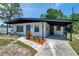 Charming single-story home featuring a covered carport, manicured landscaping, and a well-maintained front yard at 6507 La Mesa Cir, Tampa, FL 33634