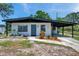 Charming single-story home featuring a covered carport and a well-maintained front yard at 6507 La Mesa Cir, Tampa, FL 33634