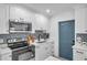 White kitchen featuring stainless appliances, stone countertops, and mosaic backsplash at 6507 La Mesa Cir, Tampa, FL 33634