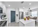 Bright, updated kitchen with white cabinetry, stainless steel appliances, and a contrasting blue door at 6507 La Mesa Cir, Tampa, FL 33634
