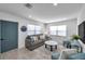 Inviting living room with a stylish sofa, modern decor, and a contrasting blue door at 6507 La Mesa Cir, Tampa, FL 33634