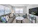Comfortable living room with a gray sofa, plush pillows, and a view from the window at 6507 La Mesa Cir, Tampa, FL 33634