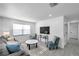 Cozy living room with natural light, a comfortable gray sofa, and stylish blue accents at 6507 La Mesa Cir, Tampa, FL 33634