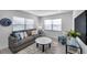 Cozy living room with a comfortable sofa, large windows, and modern decor at 6507 La Mesa Cir, Tampa, FL 33634