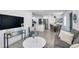 Open-concept living room featuring a dining area, kitchen island, and sleek, modern design elements at 6507 La Mesa Cir, Tampa, FL 33634