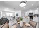 Open-concept living space with a modern kitchen, dining area, and living room, perfect for entertaining at 6507 La Mesa Cir, Tampa, FL 33634