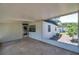 Screened-in porch with view of backyard and house exterior at 6507 La Mesa Cir, Tampa, FL 33634