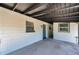 Side view of charming single-story home featuring a covered carport and side door at 6507 La Mesa Cir, Tampa, FL 33634