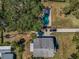 Aerial view shows property layout with house, long driveway, mature trees, and pool at 6521 Oelsner St, New Port Richey, FL 34652