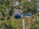 Aerial view displays property including house, long driveway, mature trees, and pool at 6521 Oelsner St, New Port Richey, FL 34652